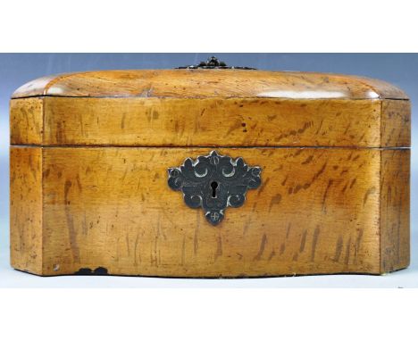 A 19th Century English antique figured oak tea caddy of unusual canted and serpentine shape having a large armorial handle an