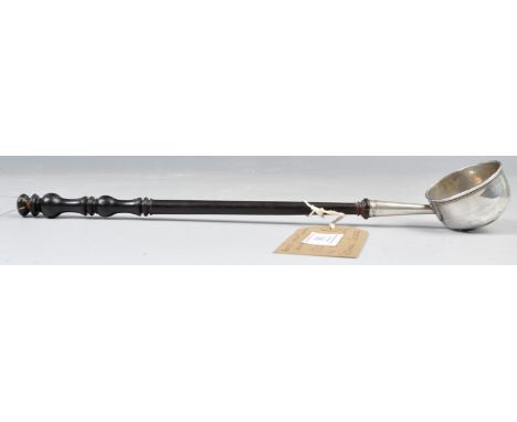 An early 18th Century Georgian George I hallmarked silver toddy ladle having a turned ebonised rosewood twin baluster handle 