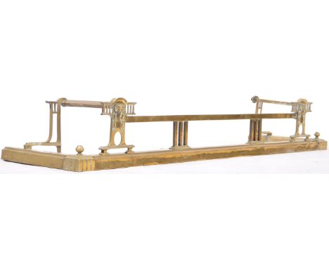 A 19th Century Victorian English antique brass fire fender / fireguard of classical form having a plain  edge with Roman clas