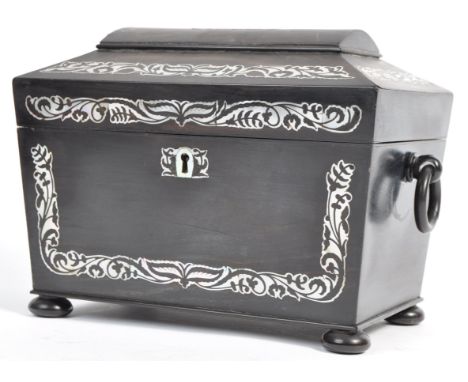 A 19th Century Victorian antique ebonised mourning tea caddy of sarcophagus form. The outer case having inlaid mother of pear