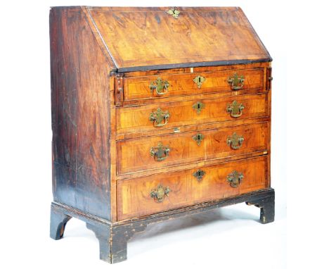 A quality 18th Century Georgian antique bureau writing desk of walnut construction having a fall front section top opening to