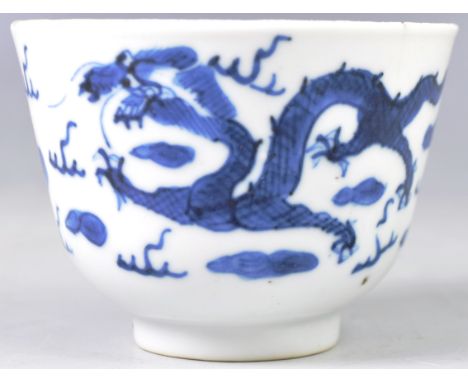 A 19th Century Chinese antique porcelain rice bowl having hand painted blue and white decoration depicting dragons chasing th