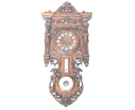 A stunning late 18th Century French antique mahogany cased clock barometer. The wall clock having a decorative carved floral 