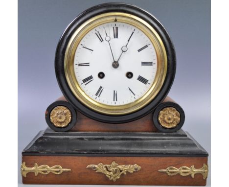 A 19th Century French antique walnut cased drumhead mantel clock of decorative form having a white enamel dial with Roman num