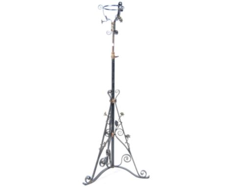 A 19th Century Victorian English antique Gothic influenced wrought iron floor standing oil lamp comprising of a Duplex oil la