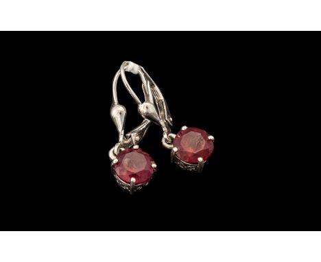 Pair of Ruby Drop Earrings, two round cut solitaires of rubies of an excellent shade of red, each of 2cts, set in platinum ve
