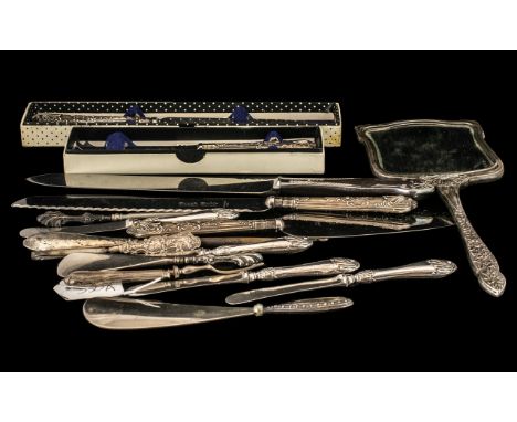 Miscellaneous Collection of Seventeen Silver Hilted Items comprising 3 large bread knives, embossed silver handled mirror, bo