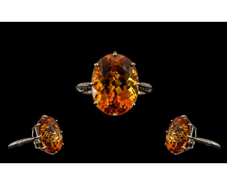 9ct Gold - Stunning Single Stone Topaz Set Ring of Large Proportions. The Oval Shaped Faceted Topaz of Fire Orange Colour, St