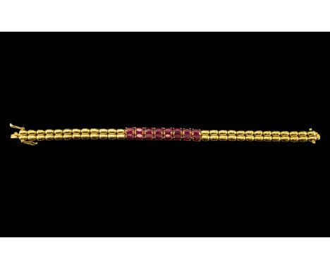 Ruby Band Bracelet, a double row of sixteen oval cut rubies, of rich red with pinkish undertones, totalling 10.5cts, forming 