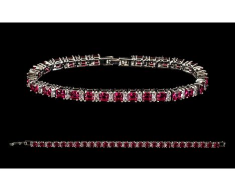 A Silver And Ruby Style Set Tennis Bracelet - Comprising 27 Ruby Style Stones, Set Between Articulated Diamonique Stations. F