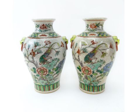 Pair of Modern Chinese Qing Dynasty Style Pottery Vases. Enamel painted flower and bird motif with mock ring handles. Signed 