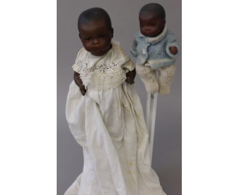 Two Armand Marseille (Germany) black bisque head baby dolls, having sleeping brown eyes, painted features, bent limb composit