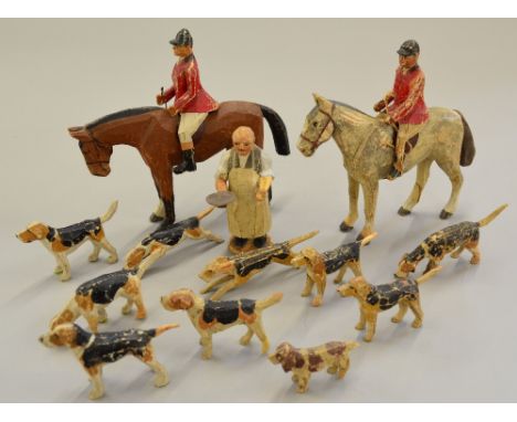 Late 19th/early 20th Century 'The Stirrup Cup' carved wooden fox hunting set, comprising an inn-keeper carrying goblets (h.11