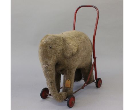 Pedigree Pets push along elephant. Stuffed toy elephant on steel push along frame. Coat is threadbare in places. Retains orig