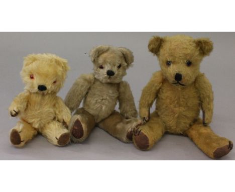 Three teddy bears, largest with glass eyes, stitched nose, mouth and claws, suede pads, height 40cm (inoperative squeaker), s