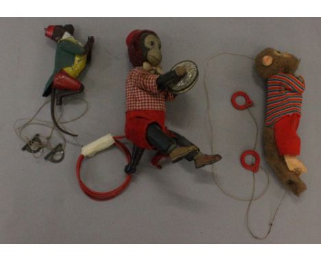 Two Climbing Monkey toys: first is tinplate, similar to Lehmann Tom toy, red hat, green jacket, length 20 cm; second is plast