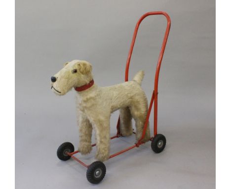 Push along terrier dog. Made in Ireland by Lines Bros. Ltd. and has a steel frame, rubber tyres, body stuffed with wood wool,