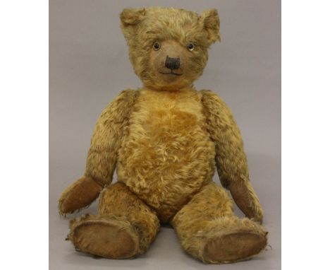 Large Chiltern 'Hugmee Bear', c.1930's, mohair with glass eyes, stitched nose and mouth, worn velveteen pads. Height 72cm. In