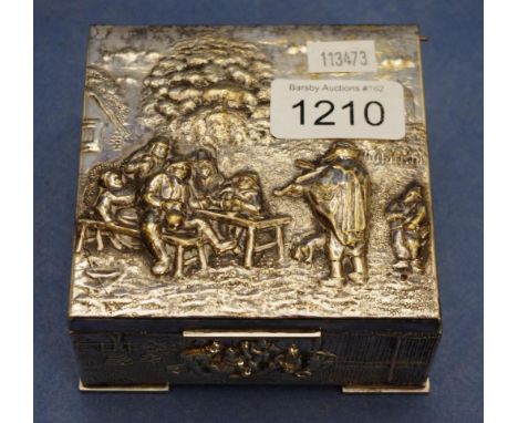 Vintage silver plated cigarette box embossed decoration of figures in a village to lid and sides. Wood lined. Length 10cm app