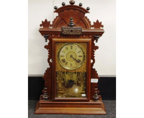 American Ingraham wood cased mantle clock carved wood case and pediment. Key and pendulum available. Appears operational, how