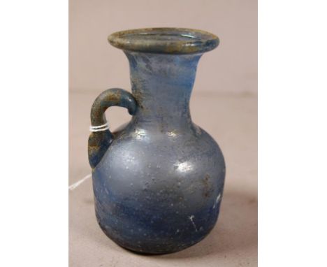 Ancient Roman glass flask blue glass body. Height 11cm approx.