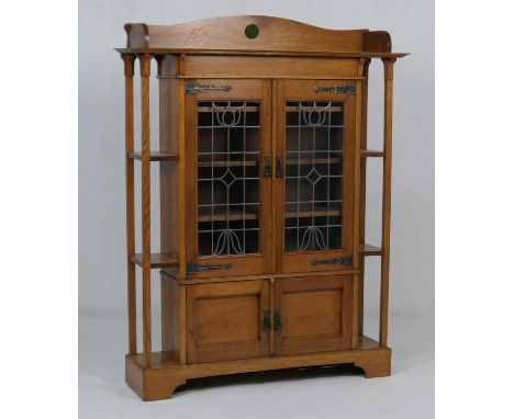 Arts and Crafts period oak display cabinet, labelled 'Bowman Brothers, Camden Town, London', the top with a three-quarter gal