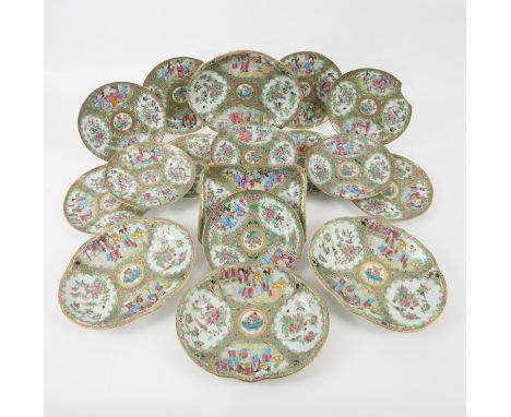 Chinese Canton famille rose dessert service, early 19th Century, typically decorated with panels of figures, birds and flower