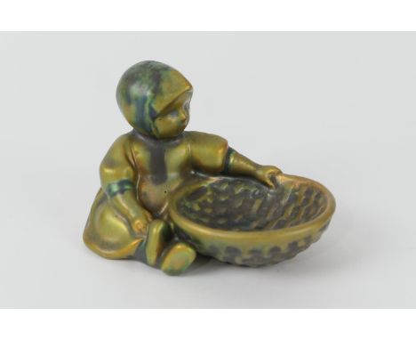 Zsolnay iridescent green glazed figural table salt, modelled as a child with a basket, gilt Zsolnay Pecs mark 'Made in Hungar