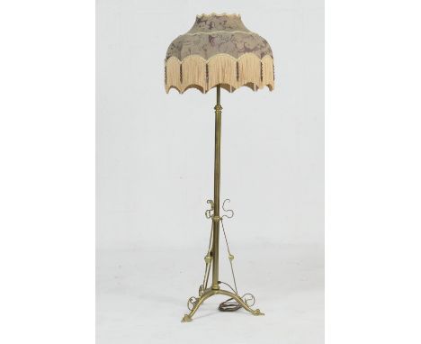 Edwardian brass extending standard lamp, in Art Nouveau style, having a purple silk damask fringed umbrella shade over a plai