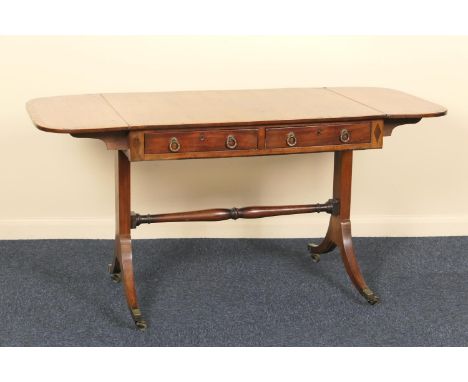 Late Regency mahogany sofa table, circa 1820, the top crossbanded with rosewood and having two frieze drawers with brass ring