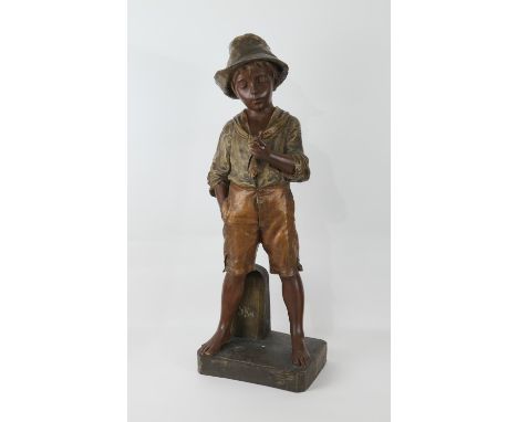 Large Goldscheider (Wien) figure, 'A pause for a smoke', a young itinerant traveller, painted and gilded terracotta, signed t