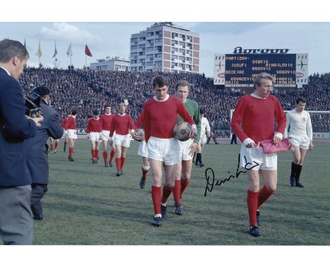 Autographed DENIS LAW 12 x 8 Photo : Col, depicting Manchester United captain DENIS LAW leading his side out onto the field o
