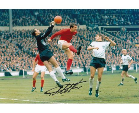 Autographed GEOFF HURST 12 x 8 photo : Col, depicting England centre-forward GEOFF HURST challenging West German goalkeeper T