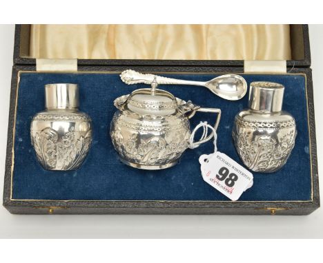 A BOXED LATE VICOTRIAN THREE PIECE CONDIMENT SET, comprising of a salt and pepper pot and a mustard, each with embossed folia