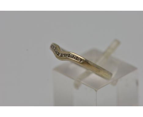 A 9CT GOLD SHAPED DIAMOND BAND RING, eleven round brilliant cut diamonds, channel set in a shaped band ring, hallmarked 9ct L