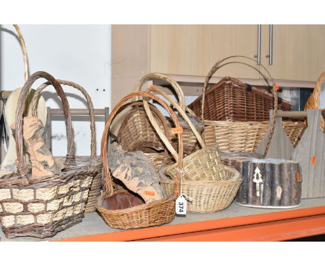 A LARGE QUANTITY OF WICKER BASKETS, comprising wicker flower baskets, a small hamper, a shopping basket, laundry basket, etc.