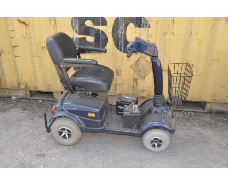 AN ELECTRIC MOBILITY FOUR WHEELED MOBILITY SCOOTER with one key and built in charger along with two spare batteries of unknow