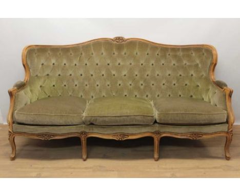 Button upholstered three piece suite, comprising three seater sofa and pair of armchairs, each with channel carved showwood f