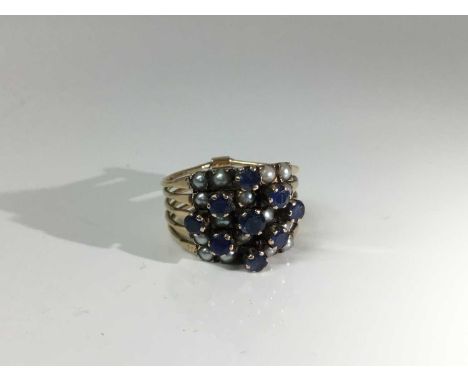 Sapphire and seed pearl five row ring with five articulated rings with round mixed cut blue sapphires and seed pearls. Ring s