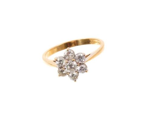 Diamond cluster ring with a flower head cluster of seven brilliant cut diamonds in claw setting on 18ct yellow gold shank. Es