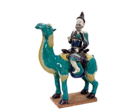 Unusual Chinese ceramic model of a camel and rider, late Qing period, painted in turquoise, yellow, aubergine and blue, the r