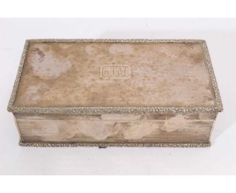 1920s silver cigarette box of rectangular form, with engine turned decoration and cast floral borders, hinged cover with engr