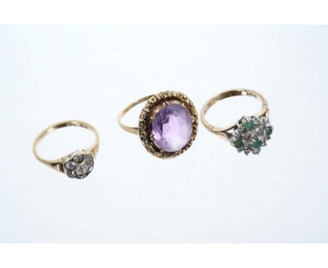 Three rings to include a diamond cluster ring, emerald and diamond cluster ring and an amethyst single stone ringCondition re