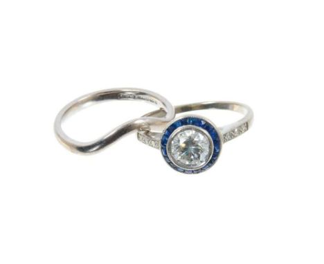 Art Deco style diamond and sapphire halo cluster ring with a round brilliant cut diamond estimated to weigh approximately 0.8