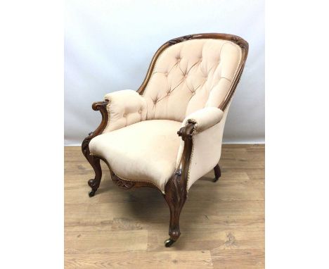 Victorian upholstered armchair, with carved showwood mahogany frame and button upholstered peach upholstery on cabriole legs 