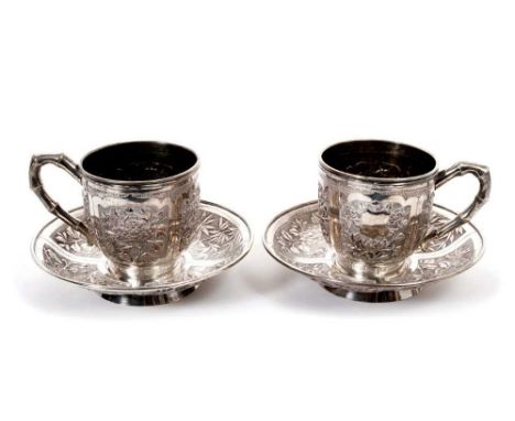 Pair late 19th/early 20th century Chinese Export silver cups and saucers, with panels of floral decoration, cups with bamboo 