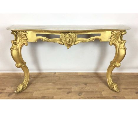 Mid Victorian Rococo-Revival giltwood and gesso console table with carrara marble top of serpentine form, raised on pierced f