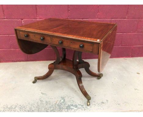 Regency mahogany sofa table with satinwood crossbanding, two opposing drawers with ebonised bun handles, splayed supports on 