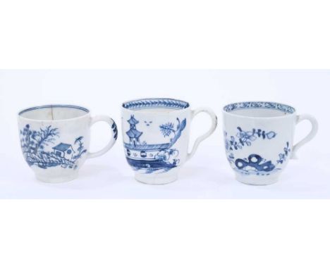 Three Lowestoft coffee cups, the first painted in blue with a flowering branch issuing from rockwork, the second printed with