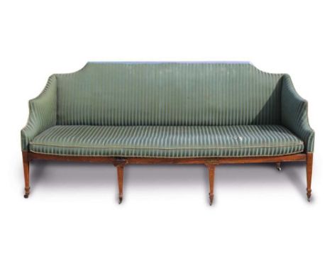 George III satinwood sofa upholstered in striped green silk, the bergère seat with loose squab cushion on square taper satinw